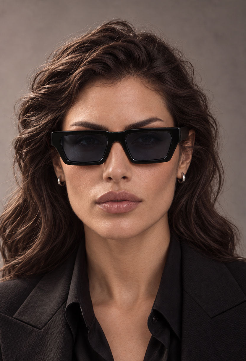 Woman with long dark hair wearing NEW STATEMENT NEXUS sunglasses in black, front view #color_black