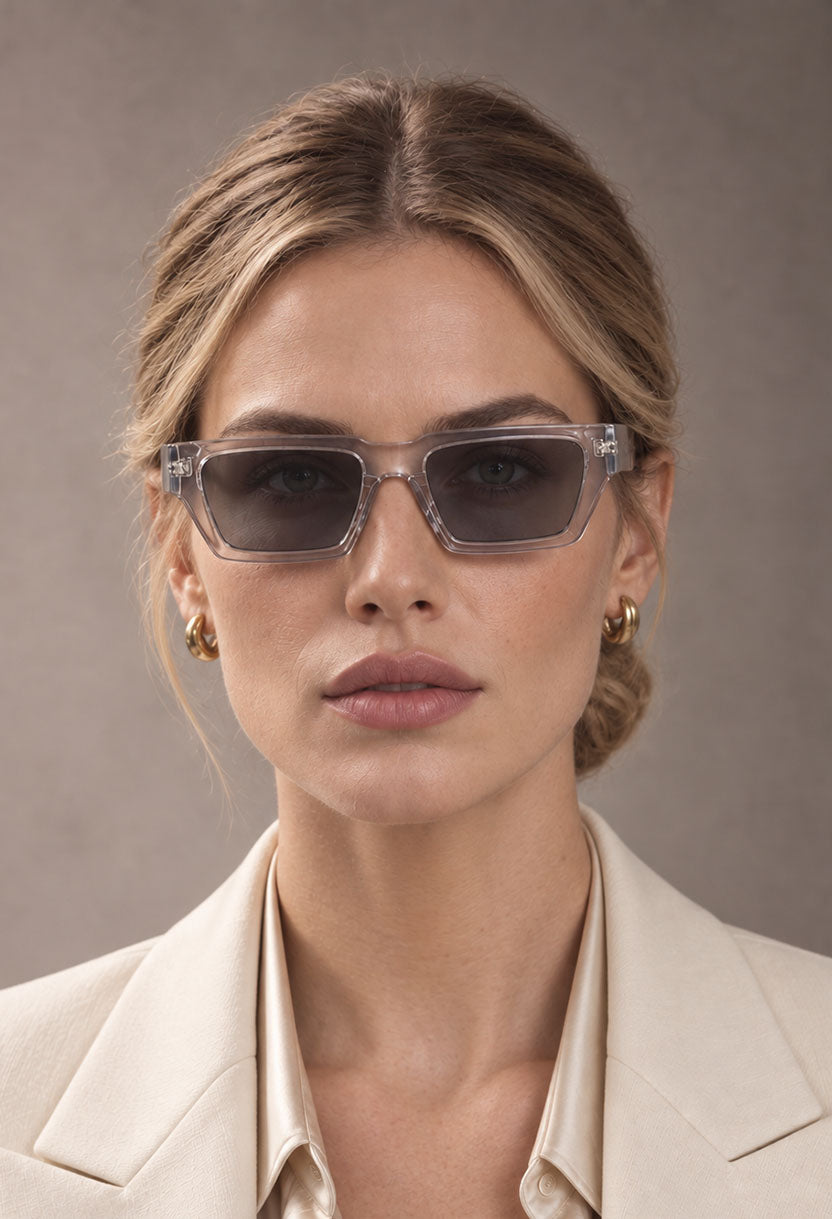 Woman in a cream blazer wearing NEW STATEMENT NEXUS sunglasses in transparent, front view #color_transparant